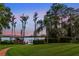 Green lawn backyard leading to a lake with a dock; lakeside enjoyment at 12706 S Lake Sawyer Ln, Windermere, FL 34786