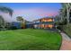 Spacious backyard showcasing a beautiful two-story home with screened-in lanai at 12706 S Lake Sawyer Ln, Windermere, FL 34786