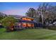 Back of house with landscaped yard, screened lanai, and beautiful water view at 12706 S Lake Sawyer Ln, Windermere, FL 34786