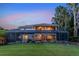 Beautiful backyard showcasing a screened-in porch and verdant landscaping creating a private outdoor space at 12706 S Lake Sawyer Ln, Windermere, FL 34786