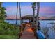 Picturesque dock featuring a covered gazebo, a wooden walkway, and a waterfront view at 12706 S Lake Sawyer Ln, Windermere, FL 34786