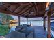 A covered dock on a lake has outdoor seating, a ceiling fan, and boat parking at 12706 S Lake Sawyer Ln, Windermere, FL 34786