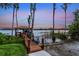 Dock view overlooking tranquil lake with boat dock, boat, and watercraft access at 12706 S Lake Sawyer Ln, Windermere, FL 34786