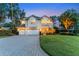 Elegant two-story home featuring a well-manicured lawn, three-car garage, and classic architectural details at 12706 S Lake Sawyer Ln, Windermere, FL 34786