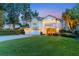 Elegant two-story home featuring a well-manicured lawn, three-car garage, and classic architectural details at 12706 S Lake Sawyer Ln, Windermere, FL 34786