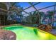 Relaxing pool area features a spa, rock waterfall, and beautiful sunset views at 12706 S Lake Sawyer Ln, Windermere, FL 34786