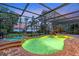 A beautiful pool with a rock waterfall and spillover spa under a screened lanai at 12706 S Lake Sawyer Ln, Windermere, FL 34786