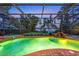 Backyard pool and hot tub with beautiful sunset and water views beyond the screened lanai at 12706 S Lake Sawyer Ln, Windermere, FL 34786