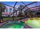 An inviting inground pool and spillover spa, surrounded by screened lanai at 12706 S Lake Sawyer Ln, Windermere, FL 34786