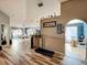 Open-concept living space featuring wood-look flooring, a dining area, and an arched entryway to another room at 135 Circle Hill Rd, Sanford, FL 32773