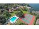 Aerial view showcasing the community pool, tennis courts, lakeside access, and residential buildings at 487 Oak Haven Dr # 487, Altamonte Springs, FL 32701