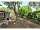 Backyard featuring a brick patio, seating, mature trees, and partial shade at 487 Oak Haven Dr # 487, Altamonte Springs, FL 32701