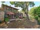 Manicured backyard with patio seating, mature tree shade, and lush landscaping at 487 Oak Haven Dr # 487, Altamonte Springs, FL 32701
