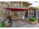 Brick patio area with comfortable outdoor seating, mature plantings, and a brick exterior at 487 Oak Haven Dr # 487, Altamonte Springs, FL 32701