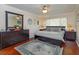 Comfortable bedroom featuring a large bed, decorative accents, and wood floors at 487 Oak Haven Dr # 487, Altamonte Springs, FL 32701