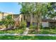 Attractive townhome featuring lush landscaping, brick accents, and a cozy front entrance at 487 Oak Haven Dr # 487, Altamonte Springs, FL 32701