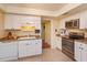 Clean kitchen with white cabinets, stainless appliances, and tile flooring at 487 Oak Haven Dr # 487, Altamonte Springs, FL 32701