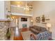 Open living room showcasing a stone fireplace, hardwood floors, and a charming loft at 487 Oak Haven Dr # 487, Altamonte Springs, FL 32701