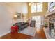 Spacious living room with high ceilings, hardwood floors, and a cozy stone fireplace at 487 Oak Haven Dr # 487, Altamonte Springs, FL 32701