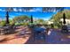 Relaxing outdoor patio area with elegant metal tables, chairs, and shaded umbrellas at 487 Oak Haven Dr # 487, Altamonte Springs, FL 32701