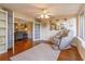 Bright sun room featuring a massage chair, hardwood floors, and access to other rooms at 487 Oak Haven Dr # 487, Altamonte Springs, FL 32701