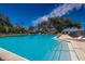 Community swimming pool with clear blue water, surrounded by lounge chairs and shaded areas at 487 Oak Haven Dr # 487, Altamonte Springs, FL 32701