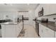 Bright kitchen with stainless steel appliances, white cabinets and gray countertops at 830 Turner Ln, Winter Haven, FL 33881