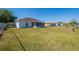 The fenced backyard offers a screened-in porch and ample space for outdoor activities or potential landscaping at 104 Birmingham Dr, Kissimmee, FL 34758