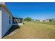 A view of the backyard showing a screened porch, fenced perimeter, and potential for creating an outdoor oasis at 104 Birmingham Dr, Kissimmee, FL 34758