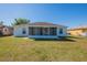 This backyard includes a screened patio, providing an ideal spot for relaxation and outdoor dining with a fenced yard at 104 Birmingham Dr, Kissimmee, FL 34758