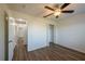 Bedroom with ceiling fan, laminate flooring, closet and hallway access at 104 Birmingham Dr, Kissimmee, FL 34758