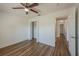 Bright bedroom features wood-look floors, a ceiling fan, and closet, offering a serene retreat at 104 Birmingham Dr, Kissimmee, FL 34758