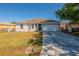 Inviting single-story home featuring a well-manicured lawn and a two-car garage at 104 Birmingham Dr, Kissimmee, FL 34758