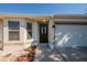 Inviting entryway with decorative front door, side windows, and a two-car garage at 104 Birmingham Dr, Kissimmee, FL 34758