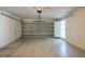 Spacious two-car garage with white walls and door, provides ample parking and storage space at 104 Birmingham Dr, Kissimmee, FL 34758