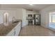 Spacious kitchen featuring stainless steel appliances and a large island with a sink and granite countertops at 104 Birmingham Dr, Kissimmee, FL 34758