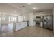 Open concept kitchen featuring stainless steel appliances, granite countertops and seamless flow to living area at 104 Birmingham Dr, Kissimmee, FL 34758