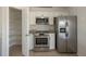 Well-equipped kitchen with stainless steel appliances, and a large walk-in pantry for storage at 104 Birmingham Dr, Kissimmee, FL 34758