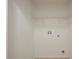 Functional laundry room includes hookups and a wire shelf, streamlining chores at 104 Birmingham Dr, Kissimmee, FL 34758