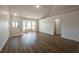 Light-filled living space with a bay window, modern flooring, and a doorway at 104 Birmingham Dr, Kissimmee, FL 34758