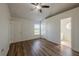 Bright main bedroom with wood-look floors, a ceiling fan, and access to the en-suite bathroom and closet at 104 Birmingham Dr, Kissimmee, FL 34758