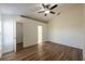 Large main bedroom showcasing a ceiling fan, high ceilings, wood flooring, and access to the en-suite bathroom at 104 Birmingham Dr, Kissimmee, FL 34758