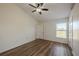 Inviting main bedroom with high ceilings, a ceiling fan, wood-look floors, and plenty of natural light at 104 Birmingham Dr, Kissimmee, FL 34758