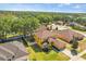 Aerial view of a home surrounded by trees, with a well-manicured lawn at 10820 Wyandotte Dr, Clermont, FL 34711