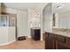 Bright bathroom with a tiled floor, double vanity with granite countertops, and walk-in shower at 10820 Wyandotte Dr, Clermont, FL 34711