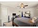 Bedroom featuring carpeting, a bed with pillows, a fan, and a TV at 10820 Wyandotte Dr, Clermont, FL 34711