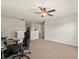 This open space features a ceiling fan and carpet at 10820 Wyandotte Dr, Clermont, FL 34711