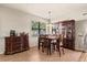 Cozy dining area with tile flooring, ample natural light, and dark-stained furniture at 10820 Wyandotte Dr, Clermont, FL 34711