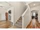 Hallway featuring wood-look flooring and a staircase leading to the upper level at 10820 Wyandotte Dr, Clermont, FL 34711