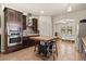 Gourmet kitchen boasts dark wood cabinets, stainless steel appliances, and tile backsplash at 10820 Wyandotte Dr, Clermont, FL 34711